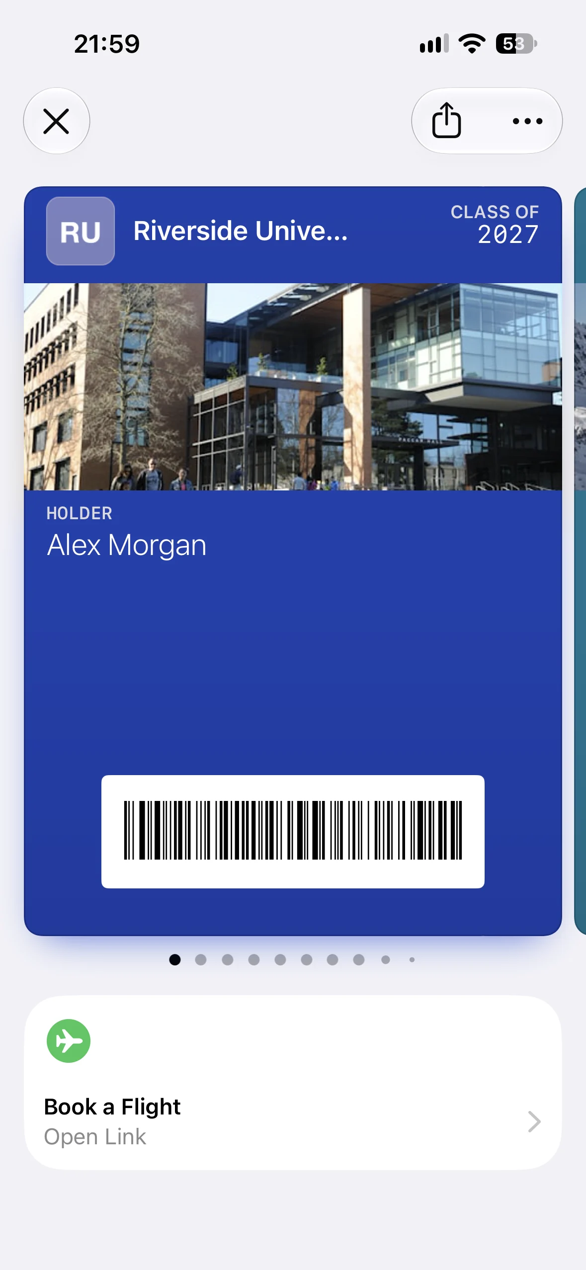 A Riverside University alumni pass in Apple Wallet with the Book a Flight Featured Action beneath it
