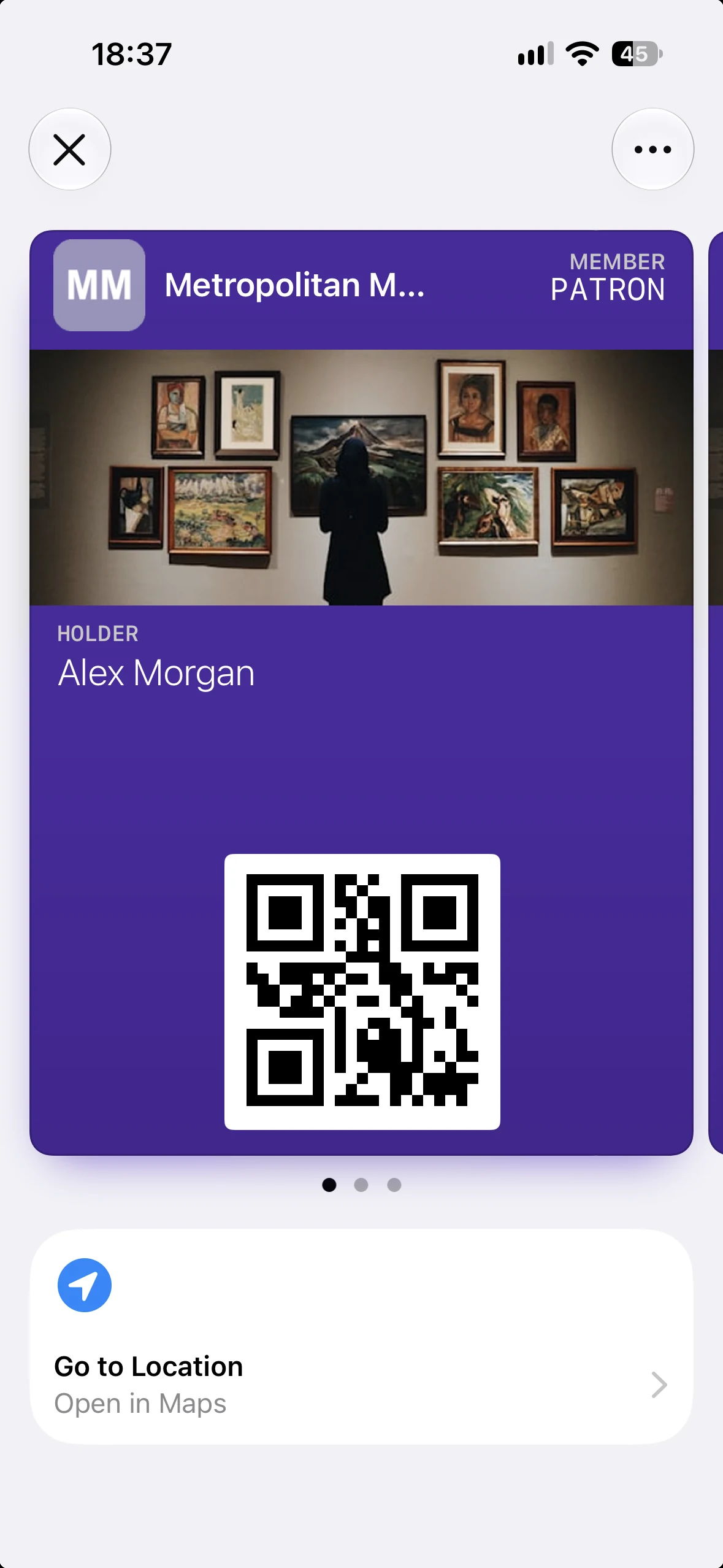 A Metropolitan Museum membership pass in Apple Wallet with the Go to Location Featured Action and its Open in Maps subtitle beneath it