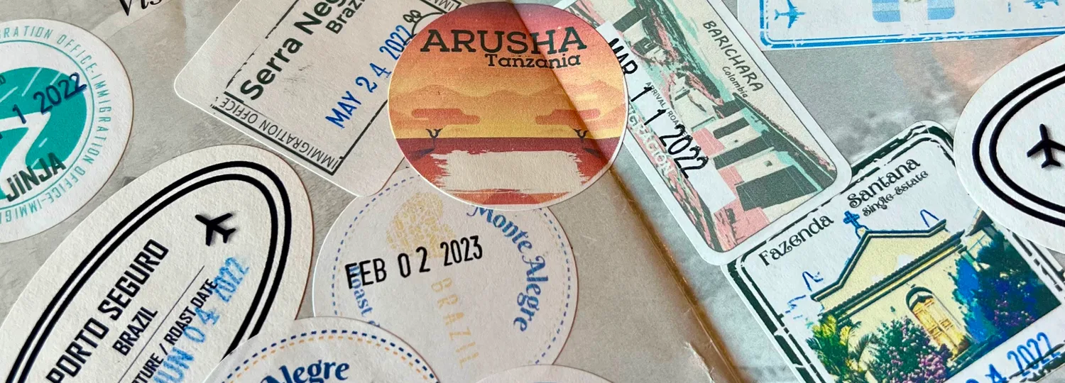 Boarding Pass Coffee passport filled with country-themed stickers and date stamps